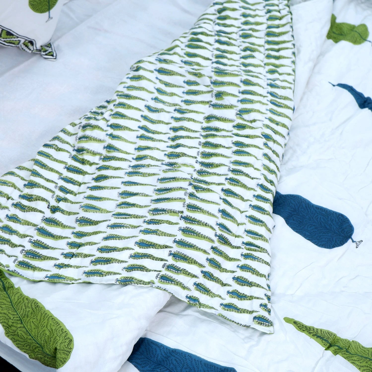 Jaipuri block print quilt set featuring intricate leaf patterns in green and blue hues